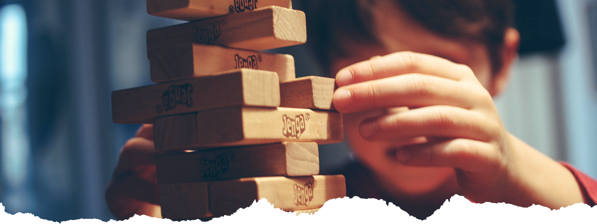 A Boy Playing Jenga Game